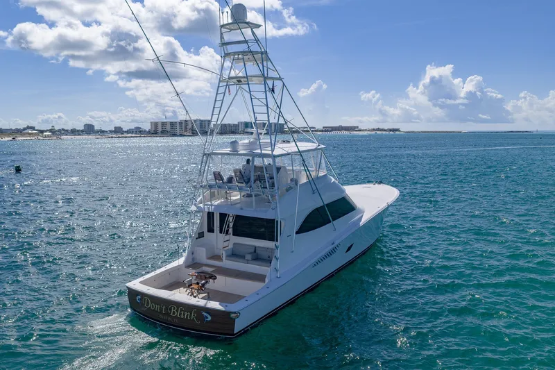 Slide: The Image of 2012 Viking 76 Convertible yacht on open water, clear sky, and distant shoreline. - 5