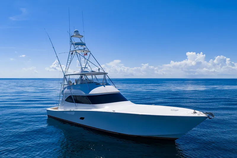 Slide: The Image of Luxury 2012 Viking 76 Convertible yacht cruising on calm blue ocean under clear sky. - 27