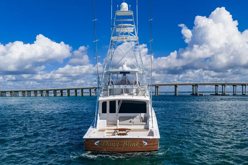 Slide: The Image of 2012 Viking 76 Convertible yacht on water, bridge and clouds in background. - 7