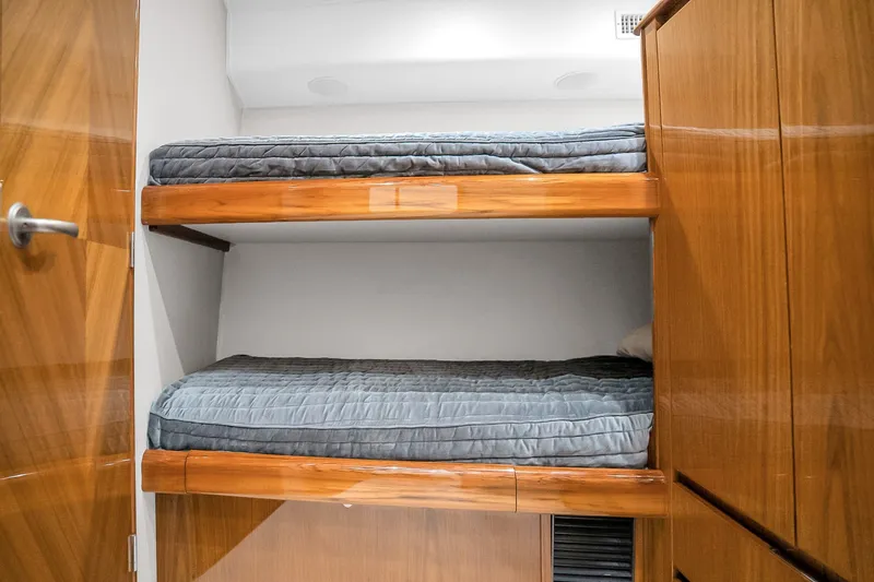 Slide: The Image of Bunk beds in 2012 Viking 76 Convertible yacht cabin with wooden finish. - 115