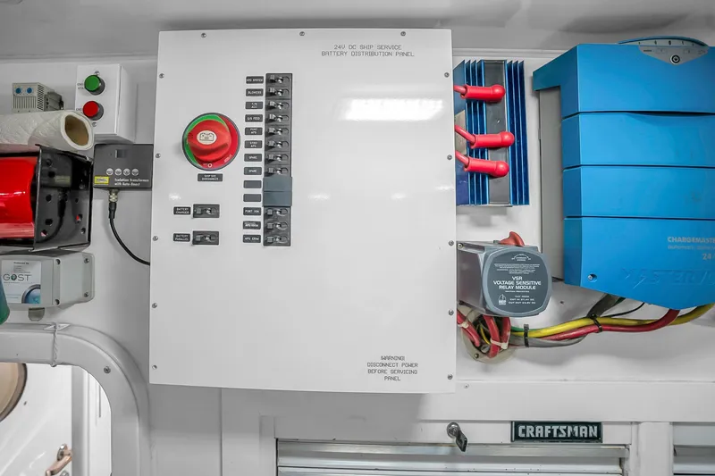 Slide: The Image of Electrical panel on a 2012 Viking 76 Convertible yacht, featuring various controls and components. - 127
