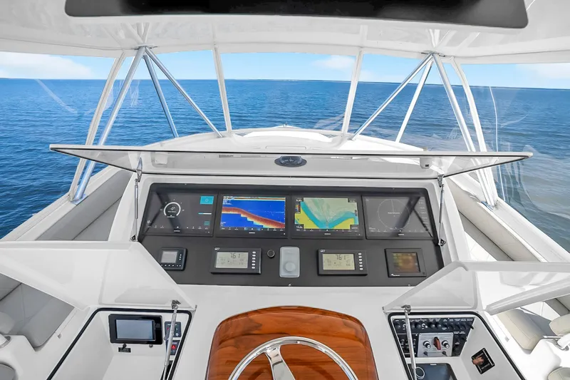 Slide: The Image of Cockpit view of 2012 Viking 76 Convertible yacht with navigation displays and ocean backdrop. - 35