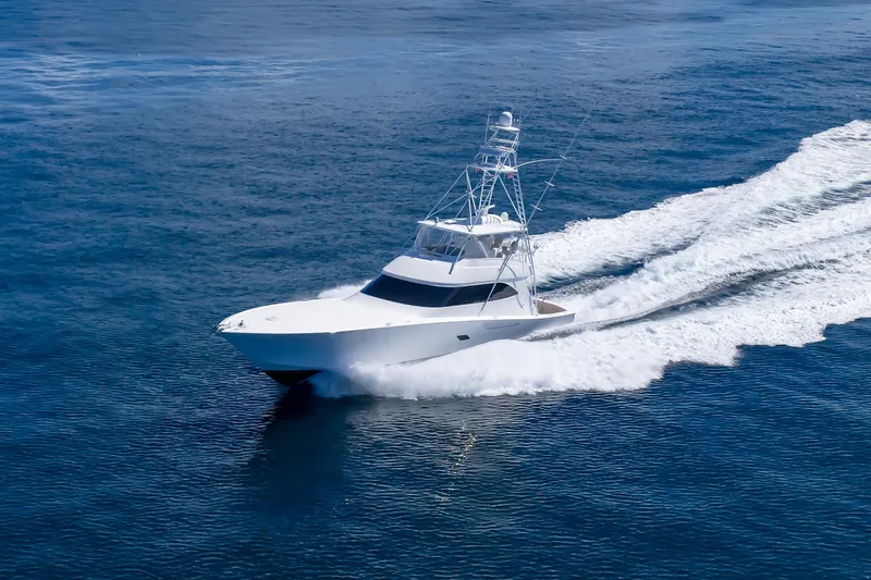 Slide: The Image of 2012 Viking 76 Convertible yacht cruising swiftly on open ocean waters. - 25