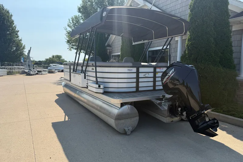 Slide: The Image of 2022 Crest Classic DLX 220 SLC pontoon boat with canopy and Mercury outboard motor. - 3