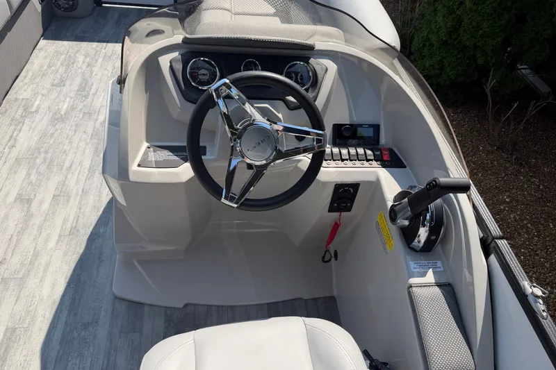 Slide: The Image of Steering console of 2022 Crest Classic DLX 220 SLC boat with modern controls. - 9