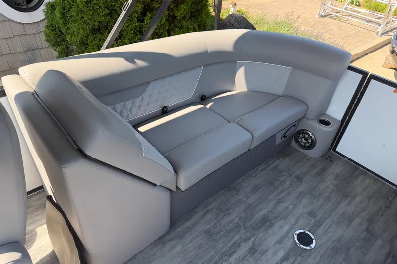 Slide: The Image of 2022 Crest Classic DLX 220 SLC boat interior with gray seating and speaker system. - 14