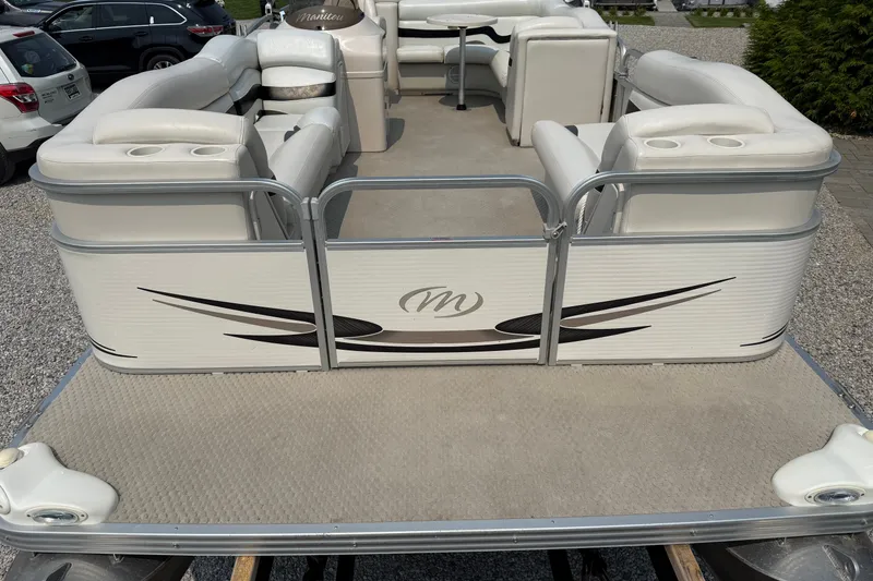 Slide: The Image of 2008 Manitou Oasis pontoon boat with white seating and stylish design. - 9