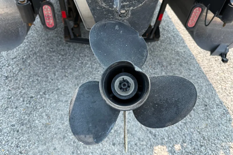 Slide: The Image of Propeller of a 2008 Manitou Oasis boat on gravel surface. - 5