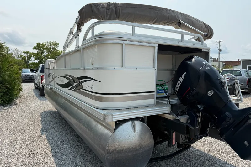 Slide: The Image of 2008 Manitou Oasis pontoon boat with Evinrude motor on gravel driveway. - 6
