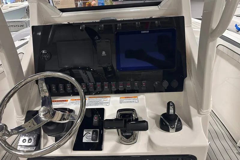 Slide: The Image of 2025 Yamaha Boats 255 FSH Sport H dashboard with steering wheel and control panel. - 14