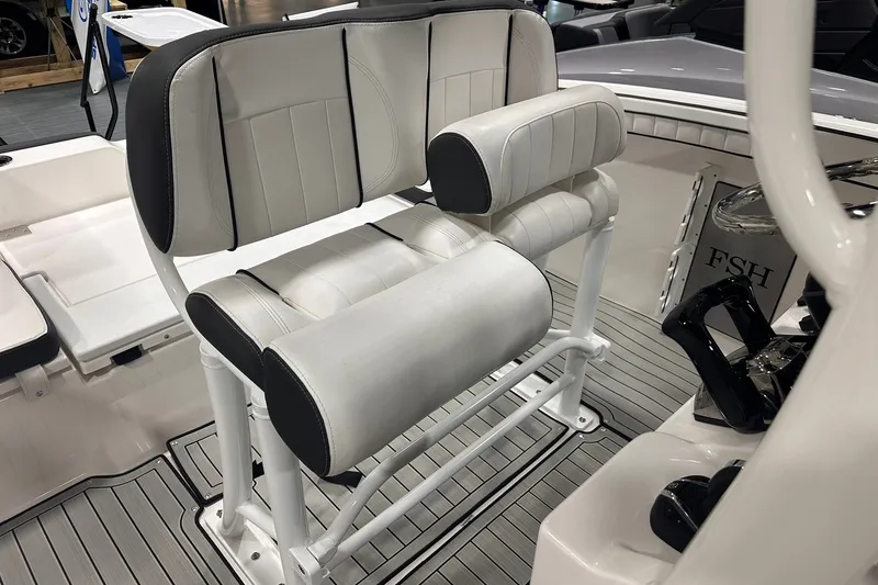 Slide: The Image of 2025 Yamaha Boats 255 FSH Sport H interior seating with white and black upholstery. - 13