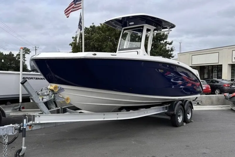 The Image of 2025 Yamaha Boats 255 FSH Sport H on trailer, displayed outdoors. - 0