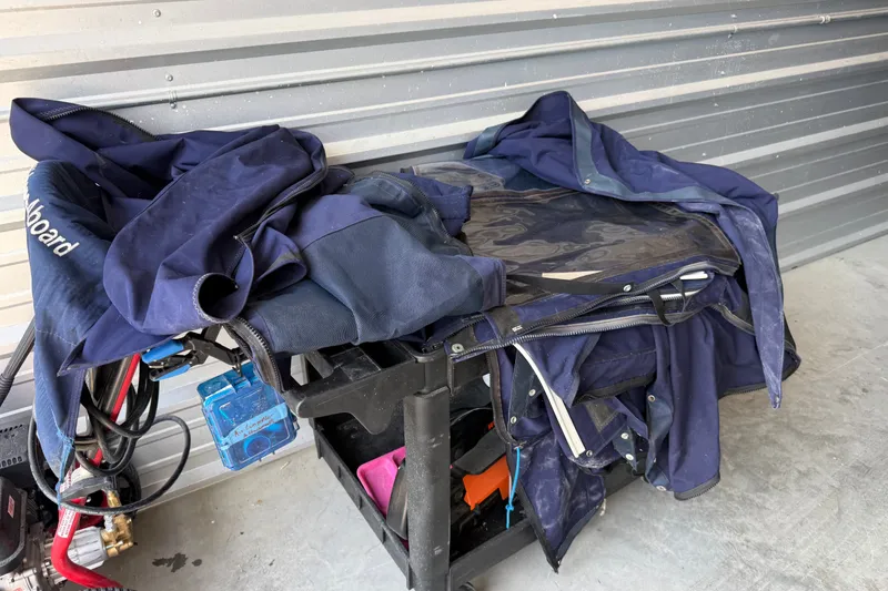 Slide: The Image of Stored boat cover for 2005 Glacier Bay 2685 Coastal Runner, folded on a cart. - 17