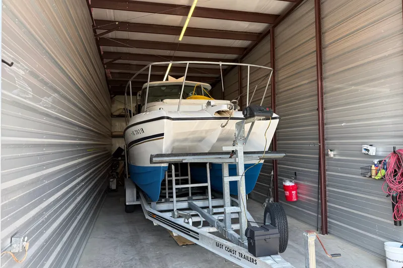 The Image of 2005 Glacier Bay 2685 Coastal Runner boat stored in a metal garage. - 0