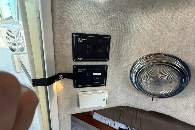 Slide: The Image of Breaker panels and light fixture inside 2005 Glacier Bay 2685 Coastal Runner boat. - 15