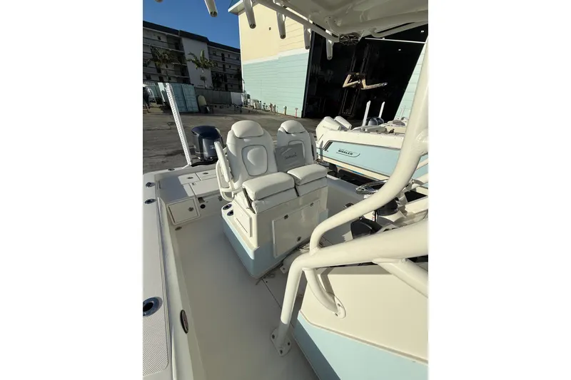Slide: The Image of 2017 Ranger 2510 Bay Ranger boat interior with dual seats and fishing equipment. - 13