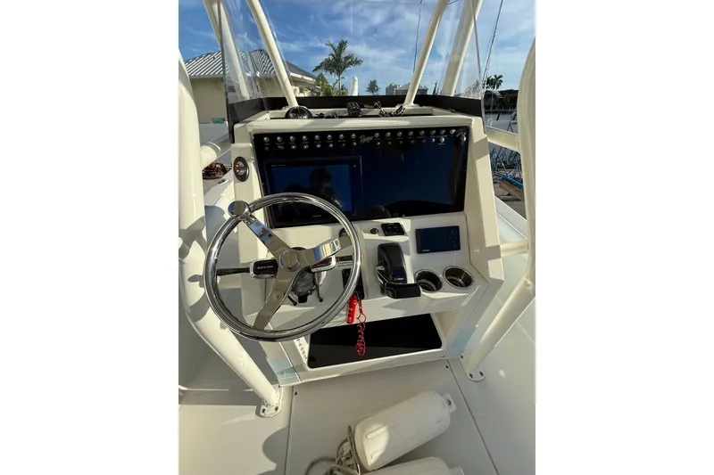Slide: The Image of 2017 Ranger 2510 Bay Ranger boat console with steering wheel and controls. - 4