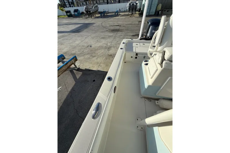 Slide: The Image of 2017 Ranger 2510 Bay Ranger boat interior with seating and storage compartments. - 12
