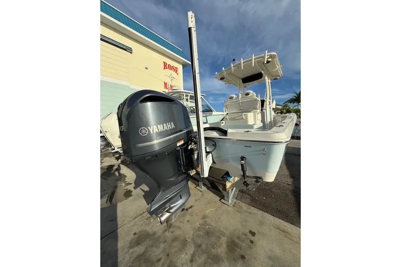 Slide: The Image of 2017 Ranger 2510 Bay Ranger boat with Yamaha outboard motor, docked outdoors. - 17