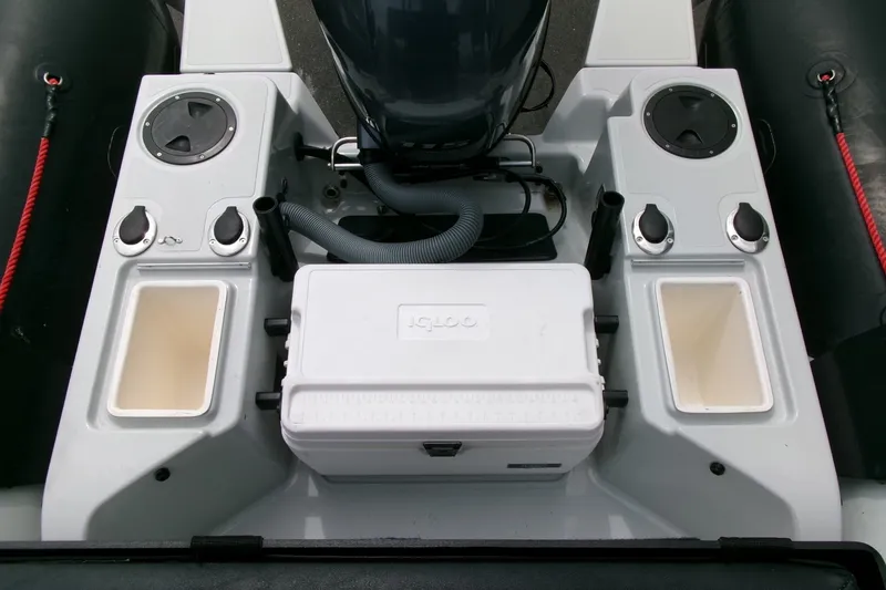 Slide: The Image of 2023 Zodiac Open 5.5 boat interior with storage compartments and cooler. - 17