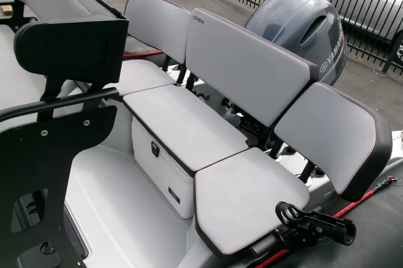 Slide: The Image of 2023 Zodiac Open 5.5 boat seating area with Yamaha engine in background. - 14