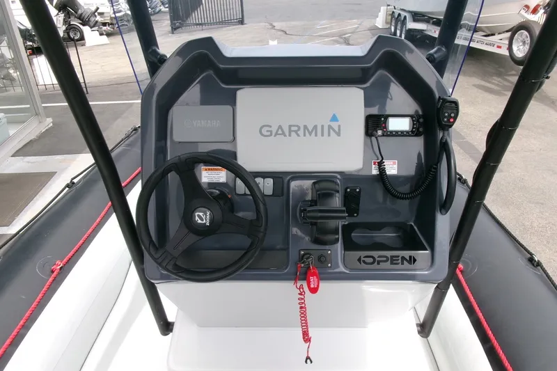 Slide: The Image of 2023 Zodiac Open 5.5 boat dashboard with Garmin navigation and Yamaha controls. - 11