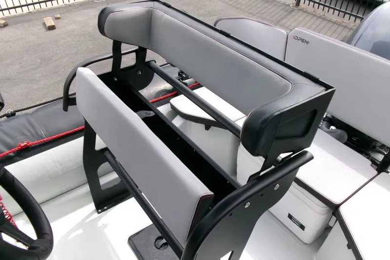 Slide: The Image of 2023 Zodiac Open 5.5 boat seating area with modern design and comfortable upholstery. - 13