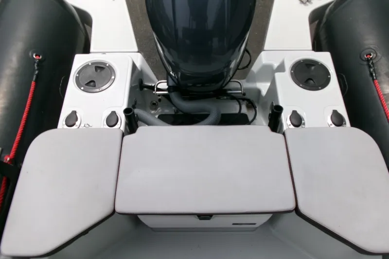 Slide: The Image of 2023 Zodiac Open 5.5 boat interior with engine and seating area. - 16