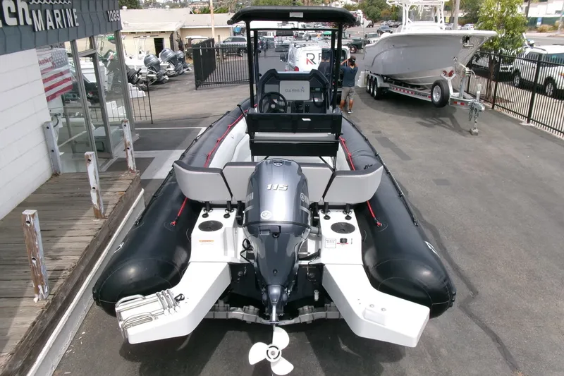 Slide: The Image of 2023 Zodiac Open 5.5 boat with Yamaha engine, parked at a marine dealership. - 21