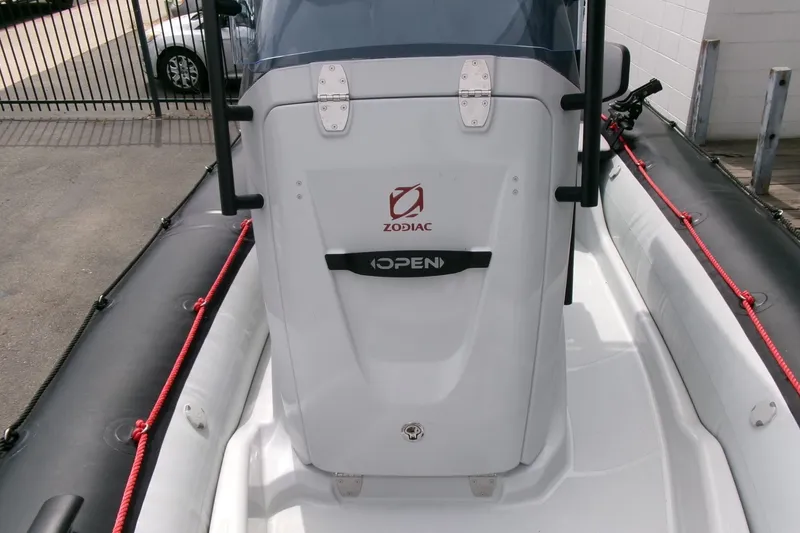 Slide: The Image of 2023 Zodiac Open 5.5 boat console with red ropes and black inflatable sides. - 7