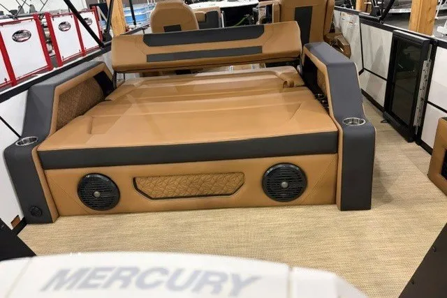Slide: The Image of 2027 Alera M23L boat interior with tan seating and integrated speakers. - 17