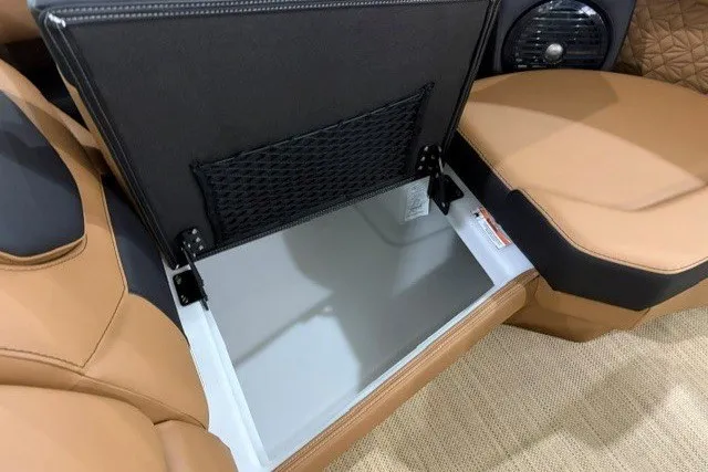 Slide: The Image of 2027 Alera M23L interior storage compartment with tan leather seating and black accents. - 13