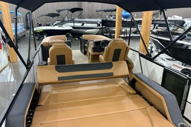 Slide: The Image of Alera M23L 2027 boat interior with tan seating, showcased in a showroom. - 16