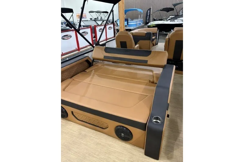 Slide: The Image of 2027 Alera M23L boat interior with tan seating and cup holders. - 12