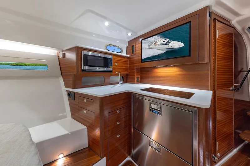 Slide: The Image of Manufacturer Provided Image: Luxurious 2025 Pursuit OS 405 Offshore yacht interior with modern kitchen amenities. - 17