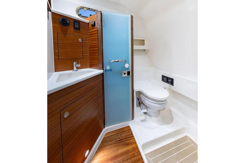 Slide: The Image of Manufacturer Provided Image: Luxurious bathroom in 2025 Pursuit OS 405 Offshore boat with modern fixtures and wood accents. - 19