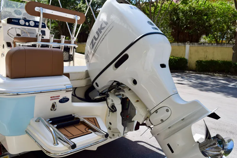 Slide: The Image of 2025 Pioneer 180 Islander boat with Suzuki outboard motor, featuring brown seating and swim platform. - 4