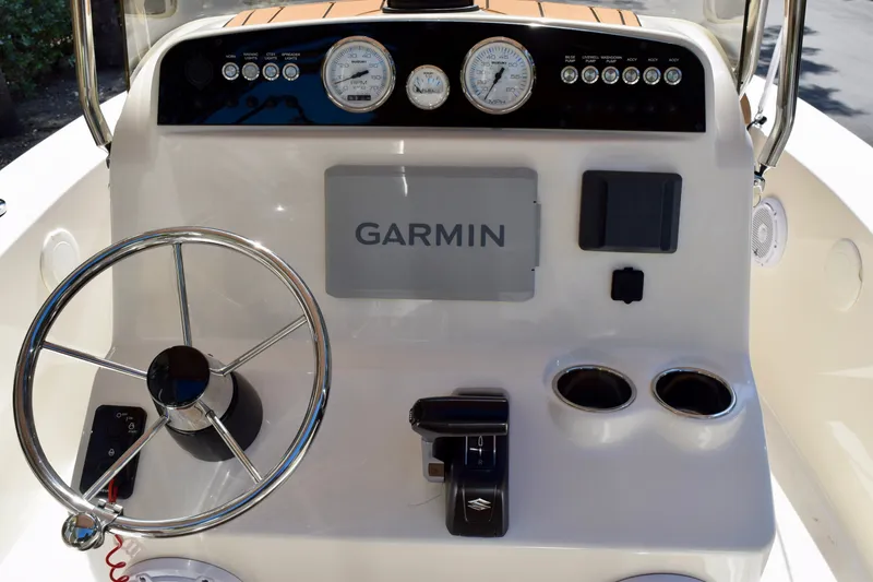 Slide: The Image of 2025 Pioneer 180 Islander boat dashboard with Garmin navigation system and steering wheel. - 7