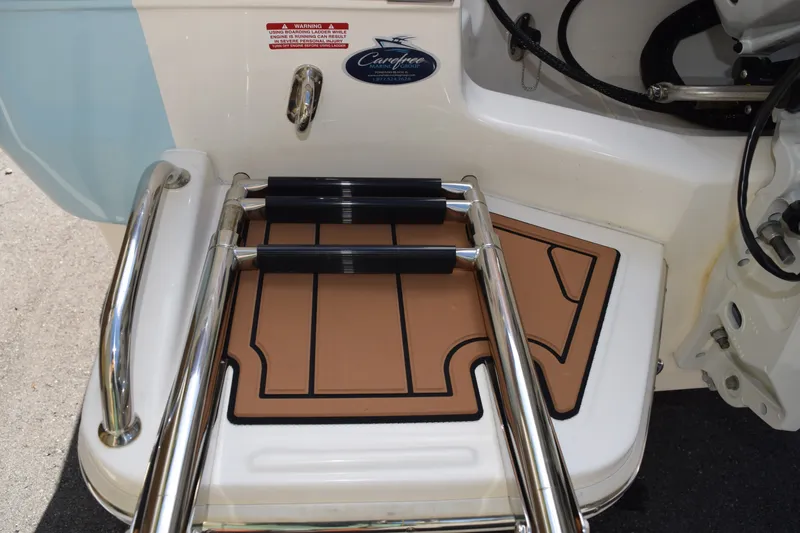 Slide: The Image of 2025 Pioneer 180 Islander boat swim platform with ladder and teak-style mat. - 12