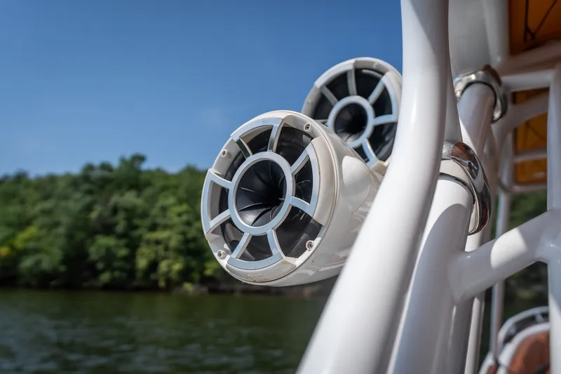 Slide: The Image of Close-up of boat speakers on a 2007 Deep Impact 360 C, with a scenic water backdrop. - 17