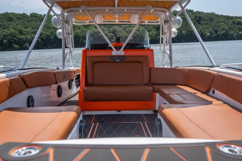 Slide: The Image of Luxury interior of 2007 Deep Impact 360 C boat with orange seating on a lake. - 33
