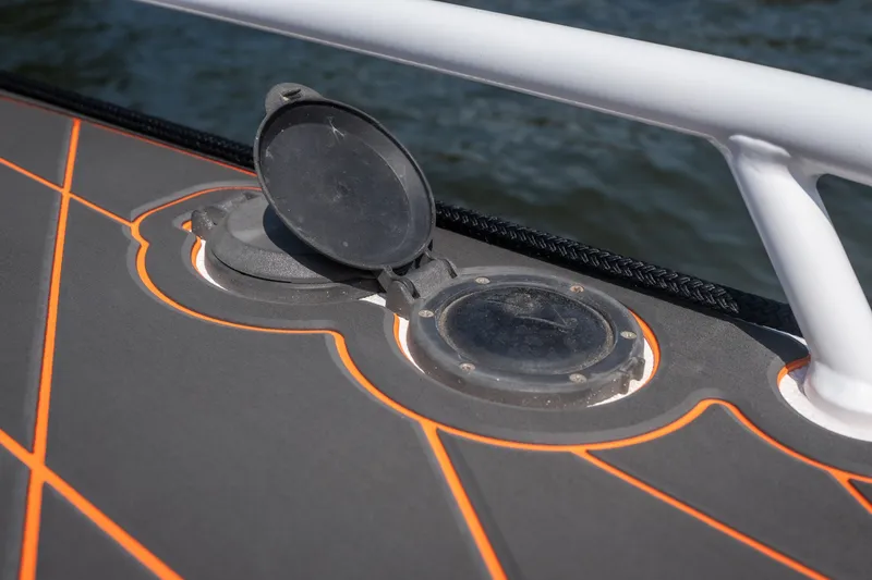 Slide: The Image of Deck detail of 2007 Deep Impact 360 C boat with orange accents and open hatch. - 28