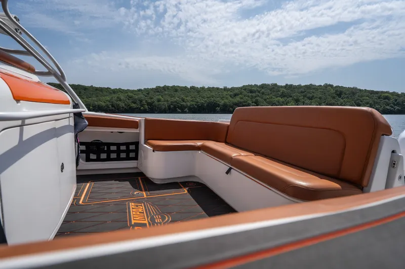 Slide: The Image of 2007 Deep Impact 360 C boat interior with brown seating, scenic lake view. - 19
