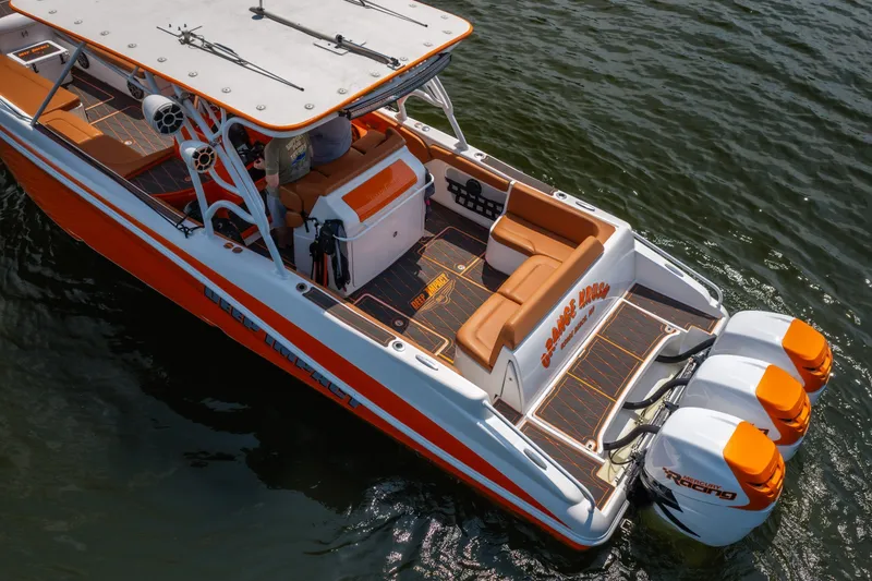 Slide: The Image of 2007 Deep Impact 360 C boat with orange accents and triple Mercury Racing engines. - 58