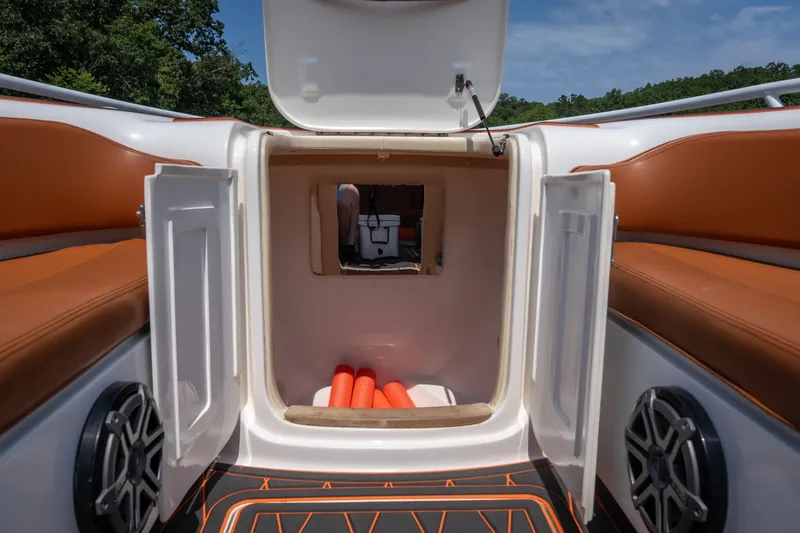 Slide: The Image of Open storage compartment on 2007 Deep Impact 360 C boat with orange seating. - 29
