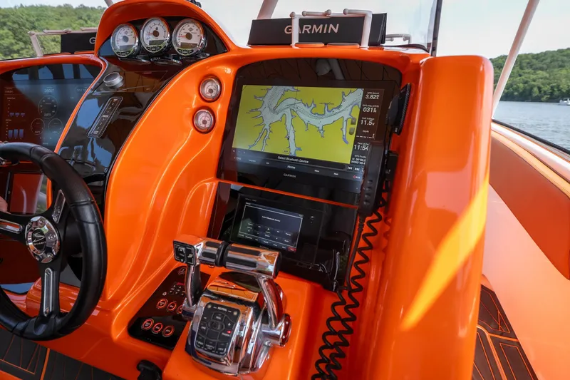 Slide: The Image of Orange dashboard of 2007 Deep Impact 360 C boat with Garmin navigation system. - 16