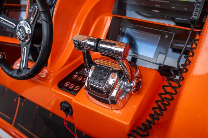 Slide: The Image of Orange helm of 2007 Deep Impact 360 C boat with steering wheel and controls. - 11