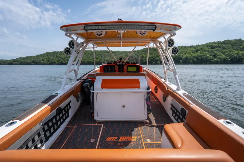 Slide: The Image of 2007 Deep Impact 360 C boat interior with orange accents on a lake. - 7