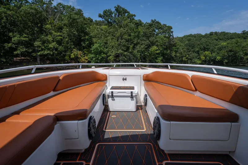 Slide: The Image of Luxurious seating on a 2007 Deep Impact 360 C boat, surrounded by lush greenery. - 25