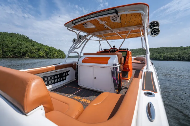 Slide: The Image of 2007 Deep Impact 360 C boat with orange and white interior on a lake. - 6